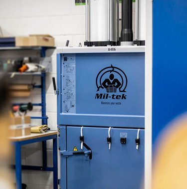 Tell me how a cardboard baler operates